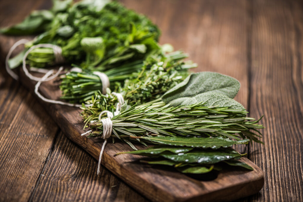 natural aromatic herbs on wooden board