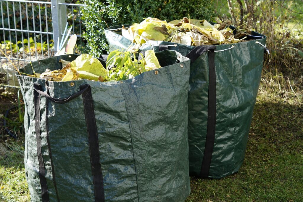 Two green bags of garden waste