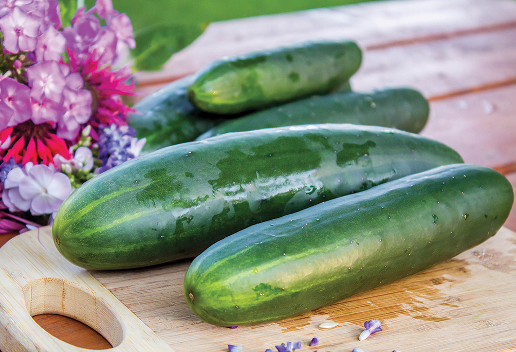 large cucumbers on a wooden cutting board