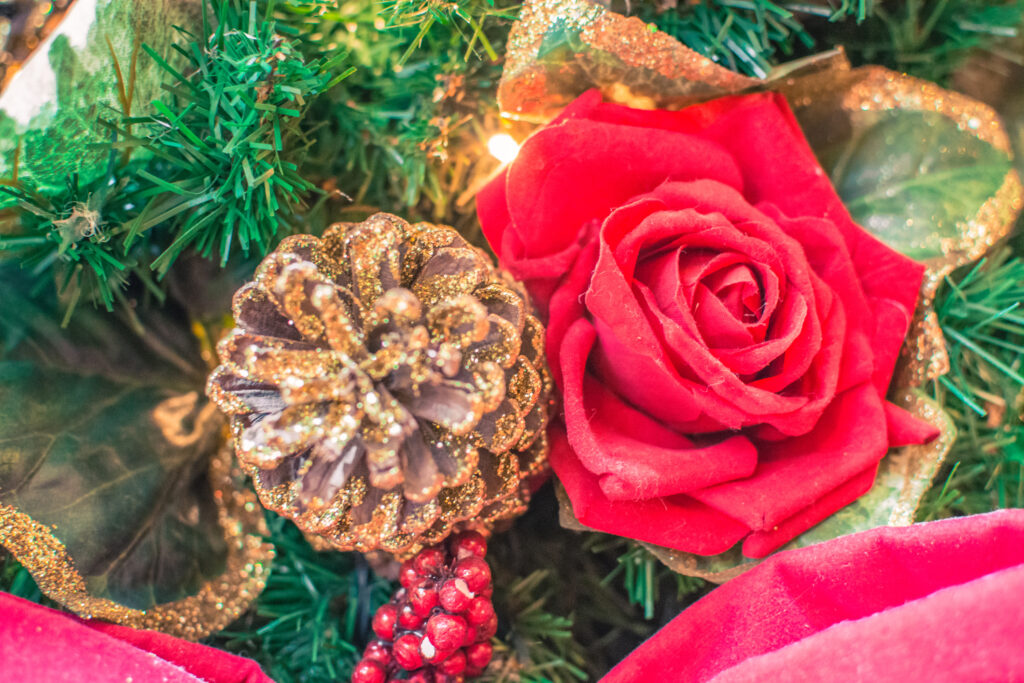 Christmas decoration with a rose and glittery pinecone