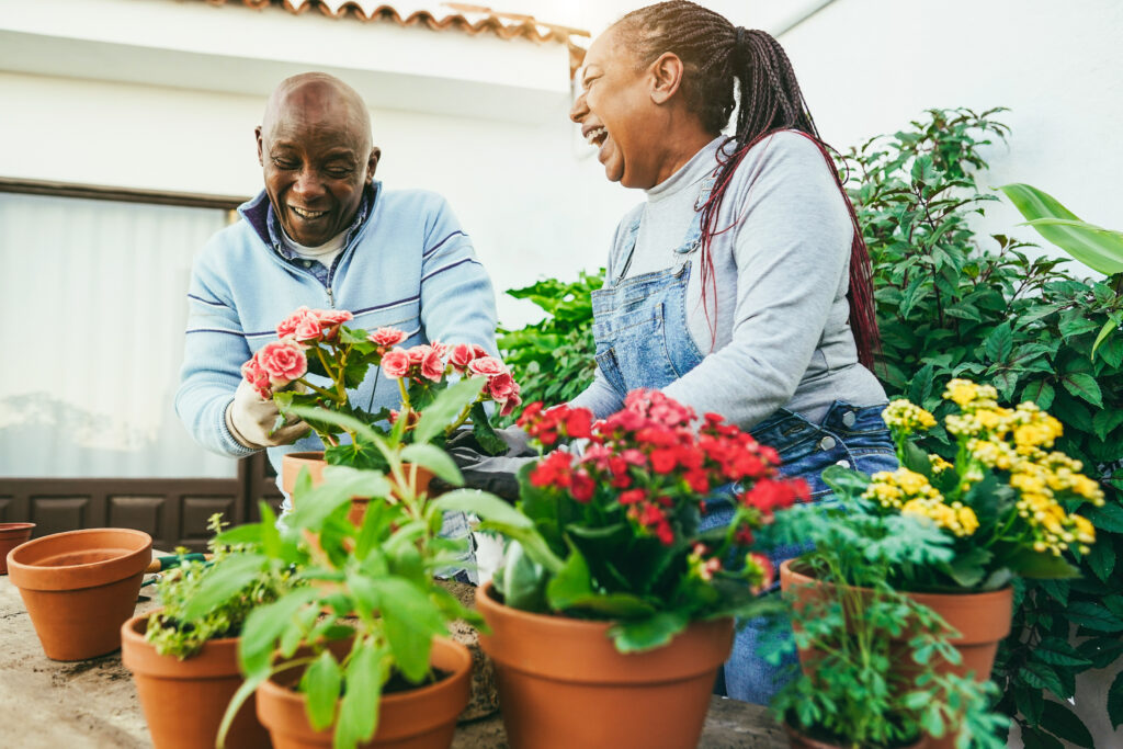 Multiracial people preparing flowers plants inside home garden outdoor