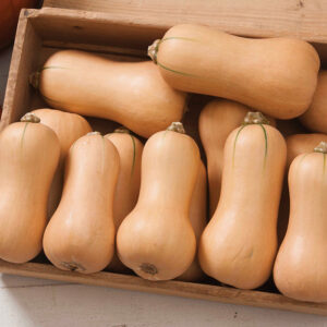 A wooden box filled with butternut squash