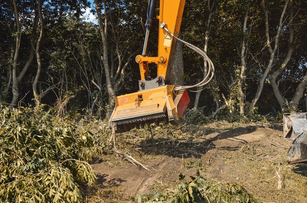 Improving environment. Mulcher. Processing of branches and weeds.